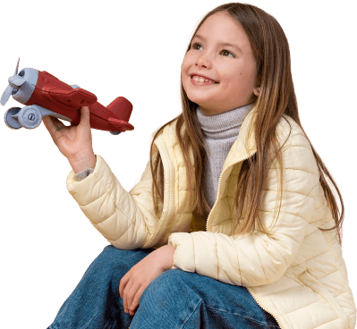 Girl holding a toy airplane