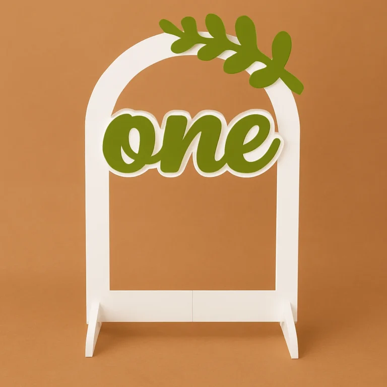 A white milestone arch stand with the word “one” and a green leaf on top