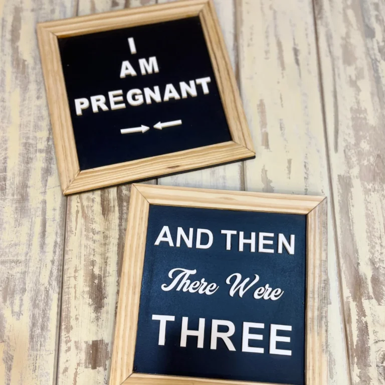 Two framed pregnancy announcement signs