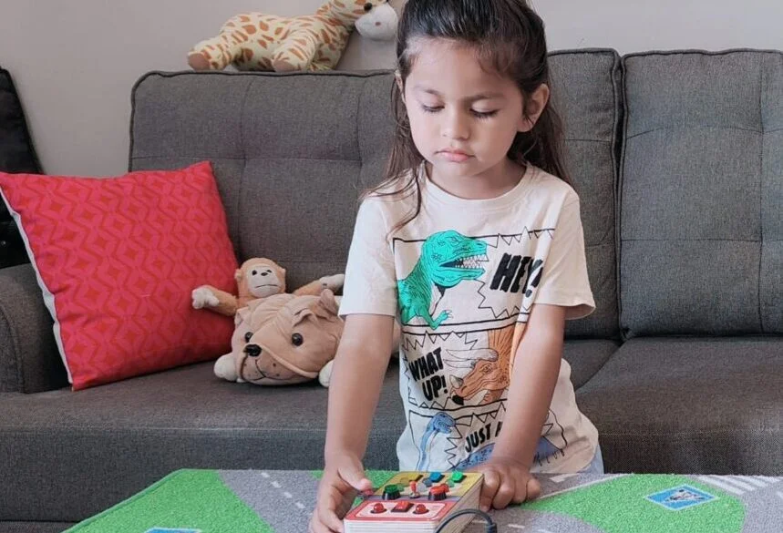girl paying with electronic toy