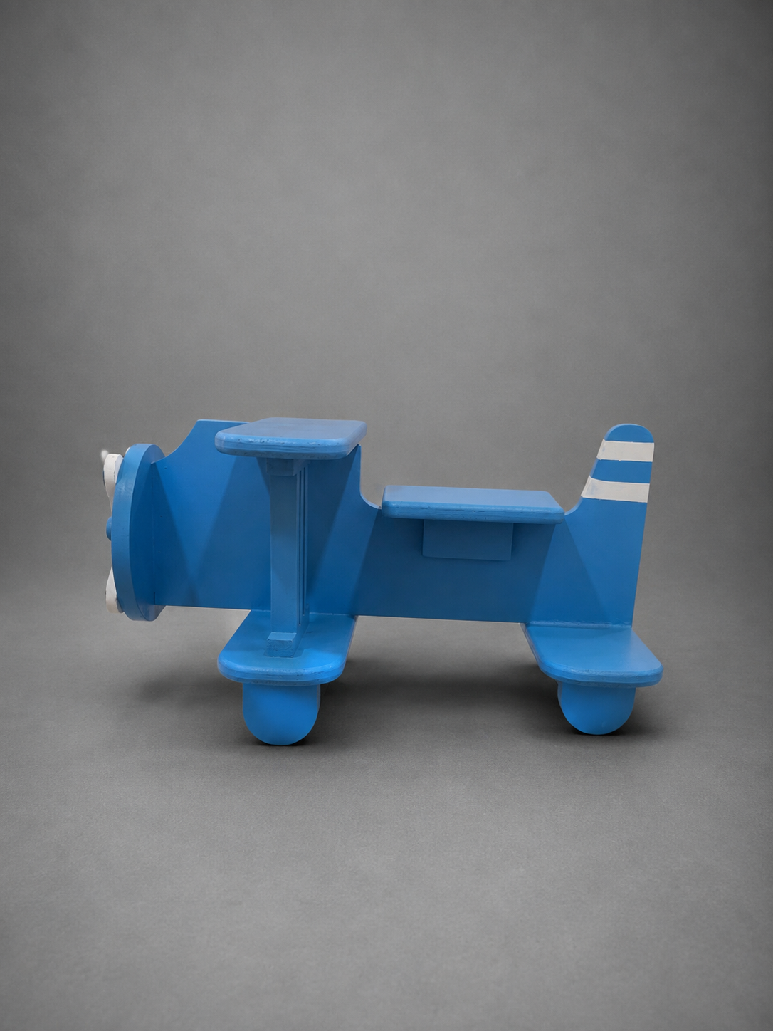 Shop a blue airplane photography prop for baby, kids, milestone and travel-themed photoshoots. A creative studio prop for professional photographers.